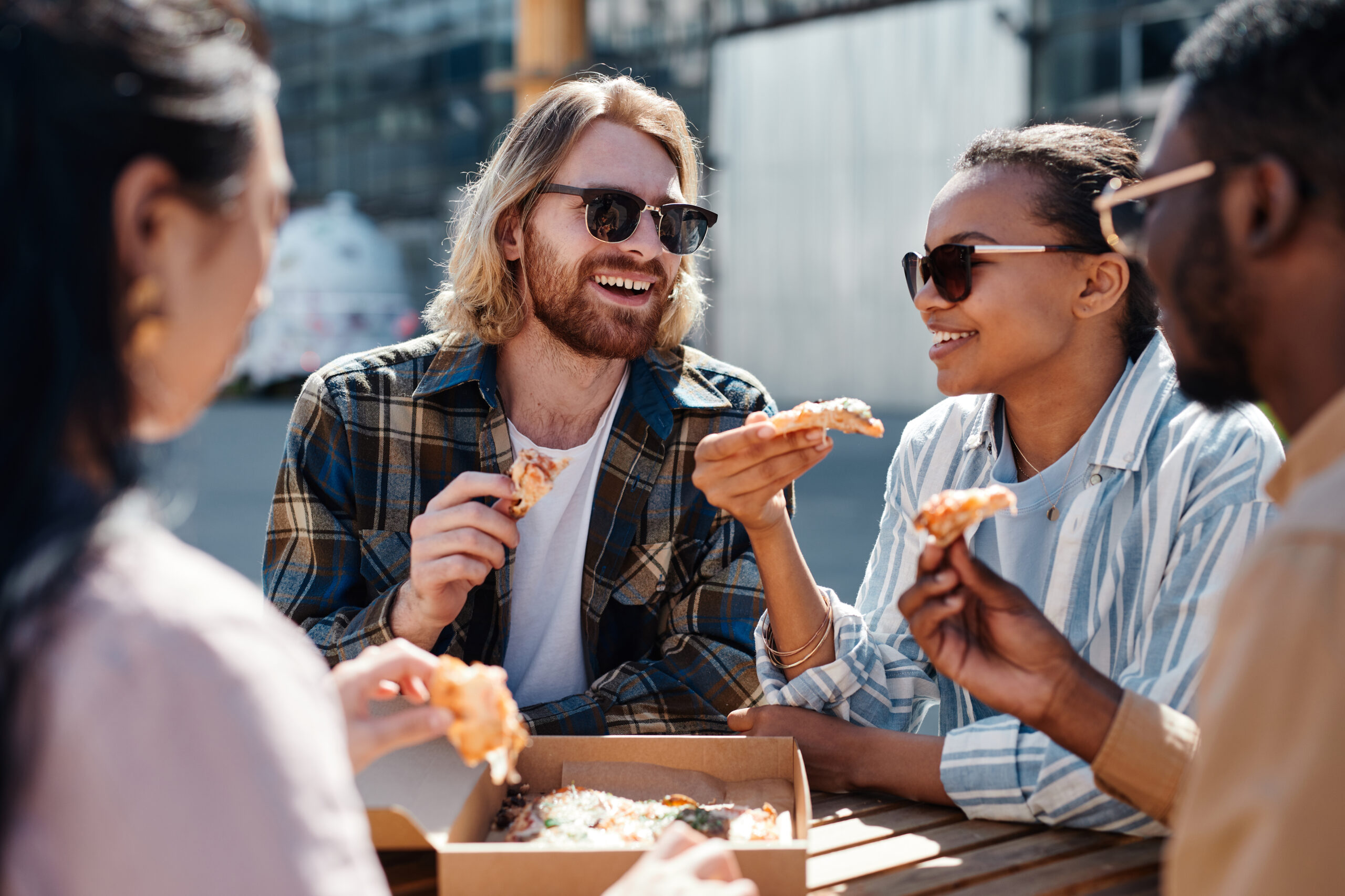 people eating pizza image on blog post top 10 outdoor patios in richmond va