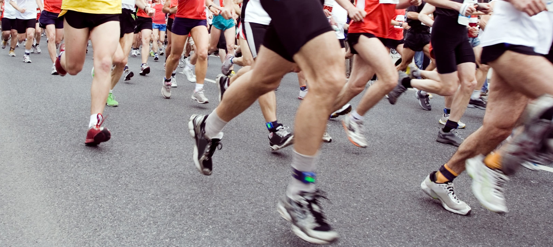 Large group of runners racing in urban area, road race, road runners, running shorts